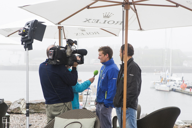 Crew members are interviewed in the race village