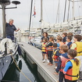 Young Opi sailors from Real Club Nautico de Arrecife talk to the owner of Latona, Swan 56 (GER)