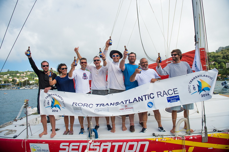 With the race banner, the crew of the Sensation Class 40 savour the moment