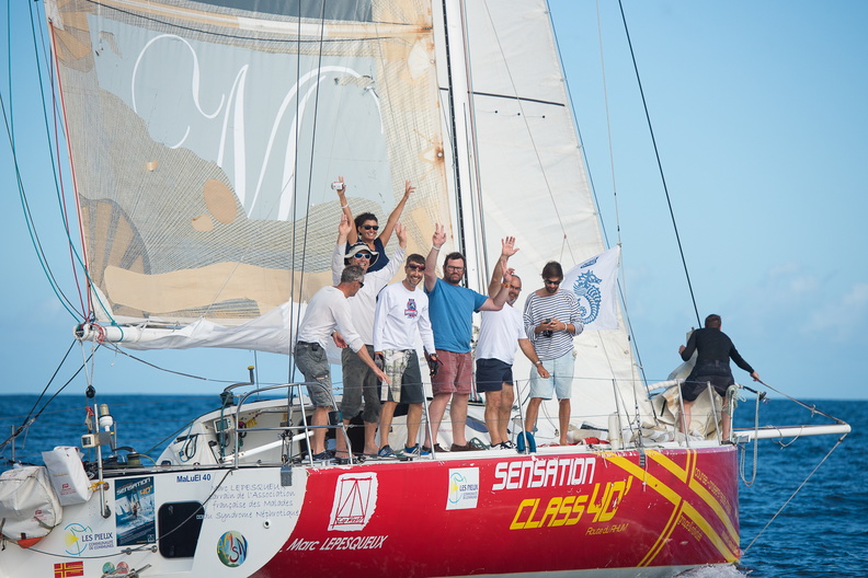 The crew cheer as they finish the race onboard Sensation Class40