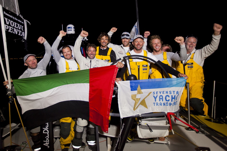 The team celebrate finishing the race in a new record time of 4 days, 13 hours, 10 minutes and 28 seconds