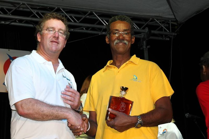 Tony, skipper of Guadeloupe Grand Large 17 receives his rum bottle from Mike Greville