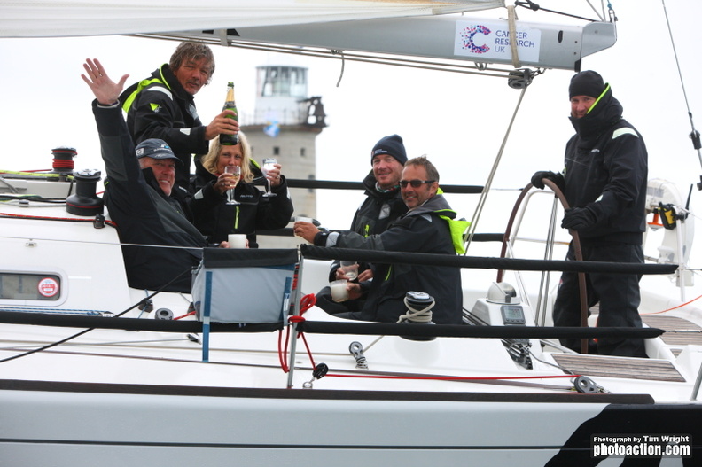 A team celebrates finishing the 2015 Rolex Fastnet Race with a bottle of champagne
