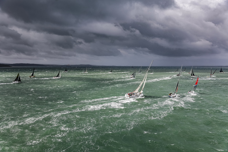 IRC One proceed through white tipped seas and thundery clouds