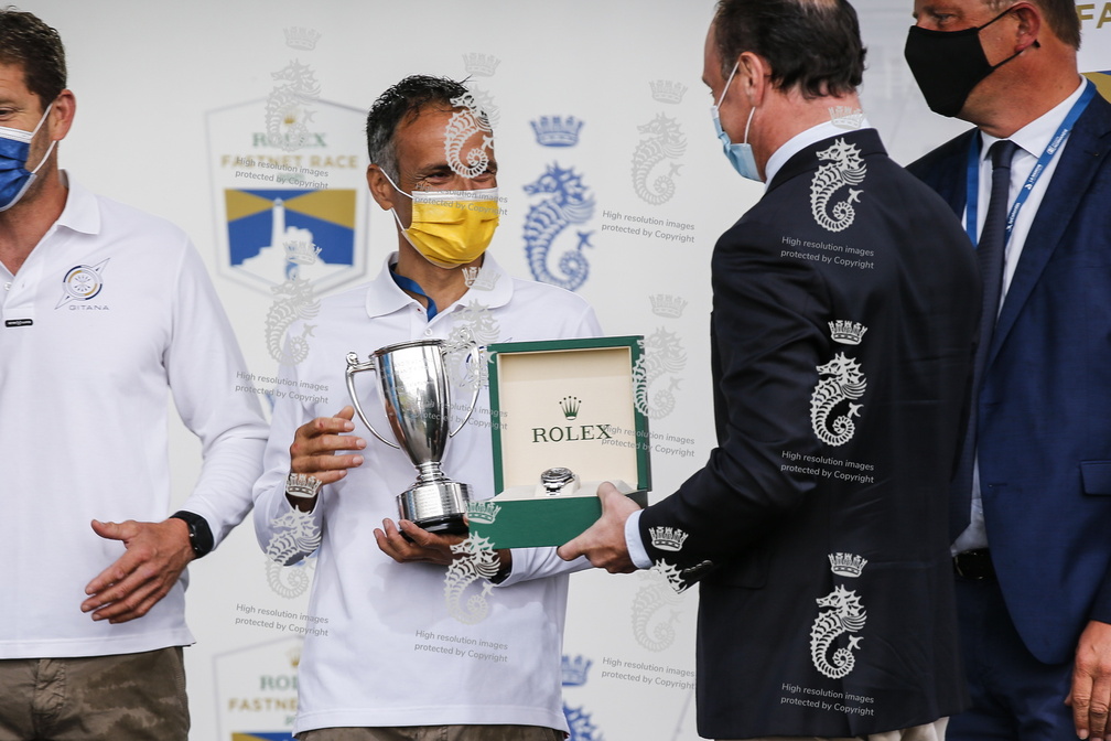 Accepting the prize for Multihull Line Honours from Rolex representative Lionel Schurch