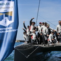 The crew of Allegra celebrate finishing the race