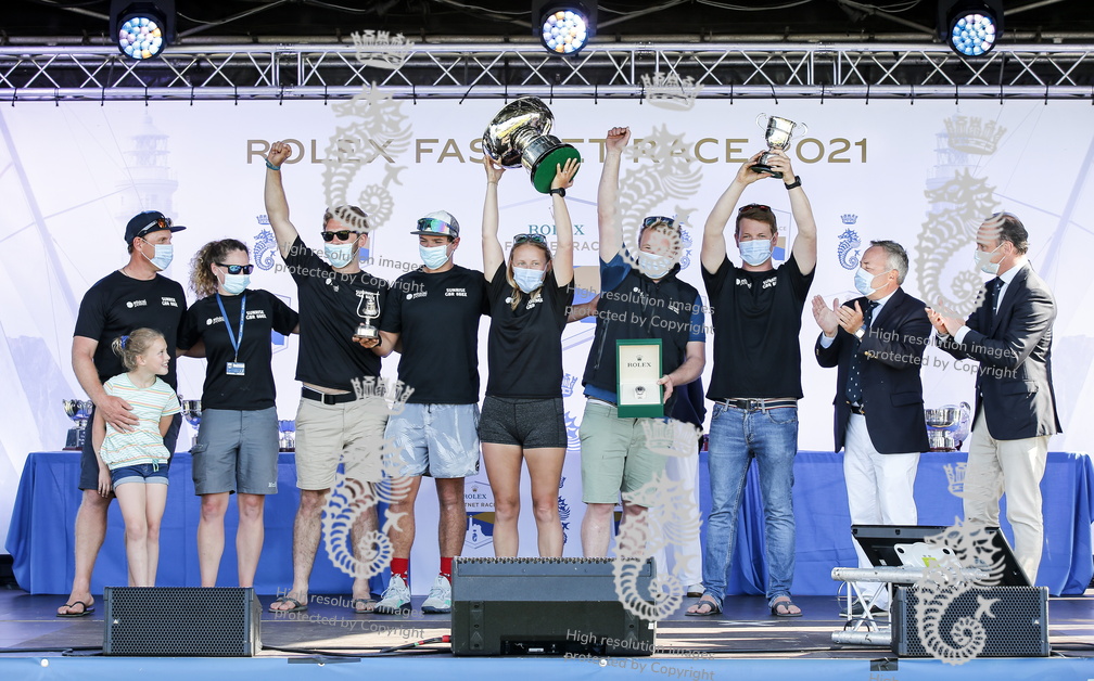 Sunrise celebrate their wins on stage with Lionel Schurch of Rolex SA and RORC Commodore James Neville