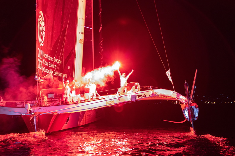 Flares at dawn on board Maserati as they celebrate multihull line honours
