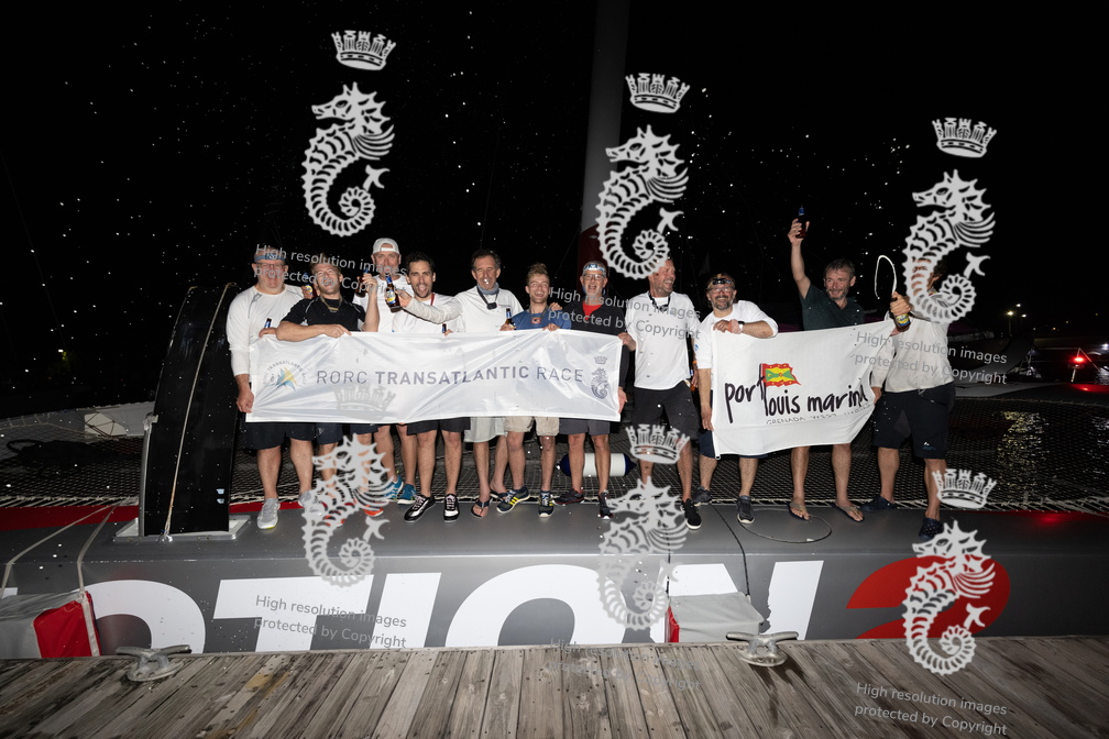 Ultim'Emotion 2 crew gather with the race banner