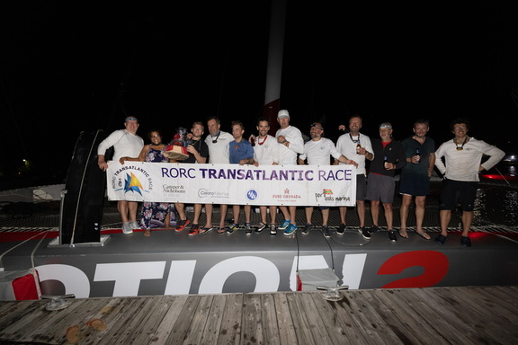 Ultim'Emotion 2 crew gather with the race banner