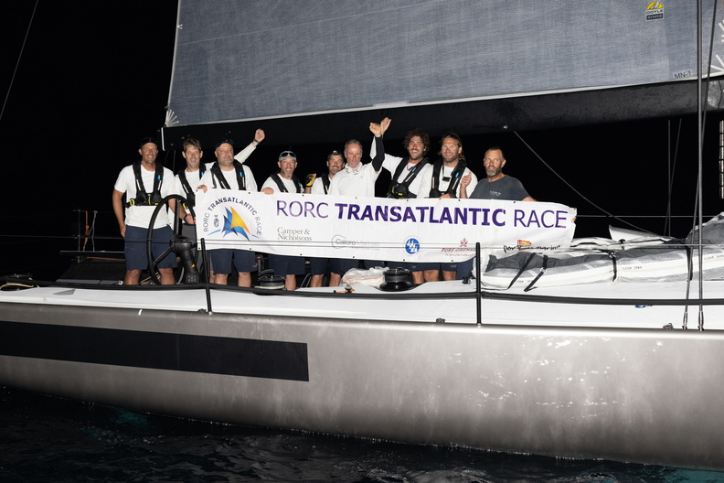 Caro crew gather with their race banner at the finish in Grenada