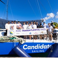 Sisi's crew - the Austrian Ocean Racing Project - pose with their banner on the deck of the VO65