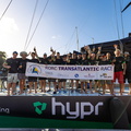 Hypr crew gather on deck with the official race banner