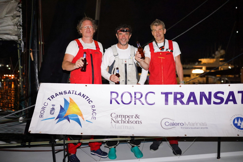 Richard Tolkien and his two crew celebrate at the end of the RORC Transatlantic Race