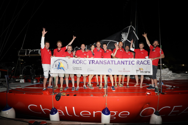 Challenge Ocean celebrate with the race banner on deck