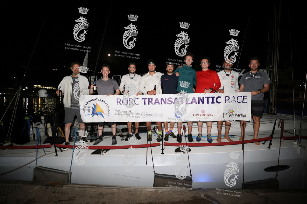 Phosphorus II's crew pose with the race banner