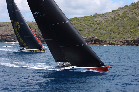 100ft Comanche, skippered by Mitch Booth, takes the lead over Dmitry Rybolovlev's 125ft Skorpios