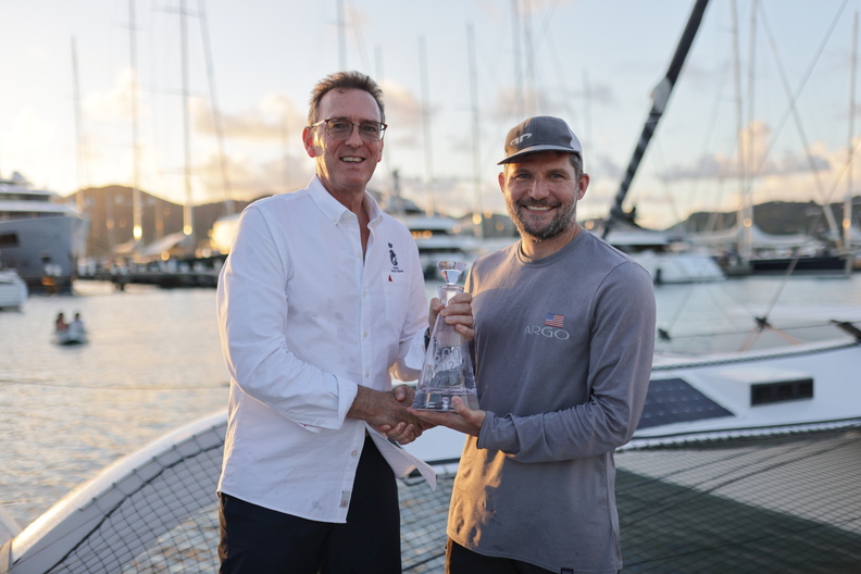 RORC CEO Jeremy Wilton presents Jason Carroll with his prize as first multihull home