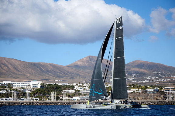 Zoulou, MOD70 sails past Marina Lanzarote on its way to the startline