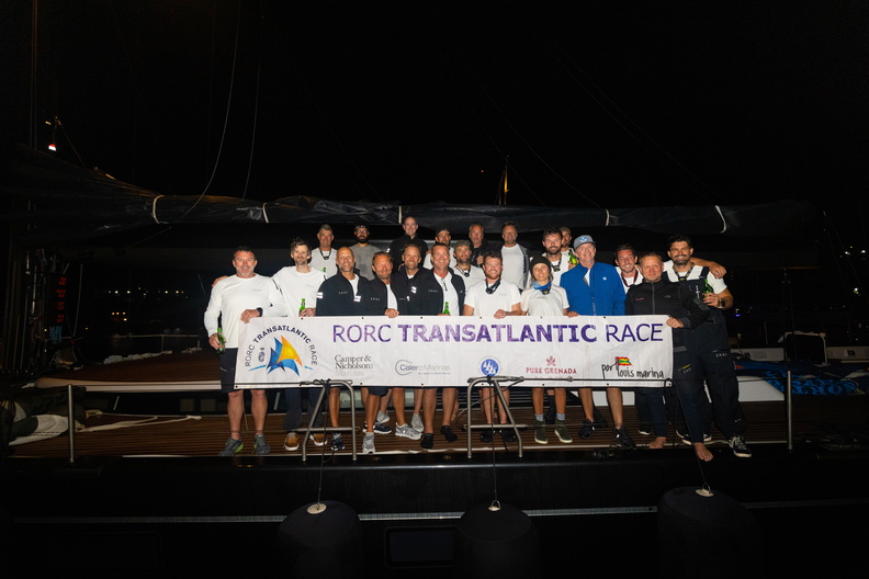 The crew of the largest yacht in the fleet, 115ft Swan Jasi, celebrate their race