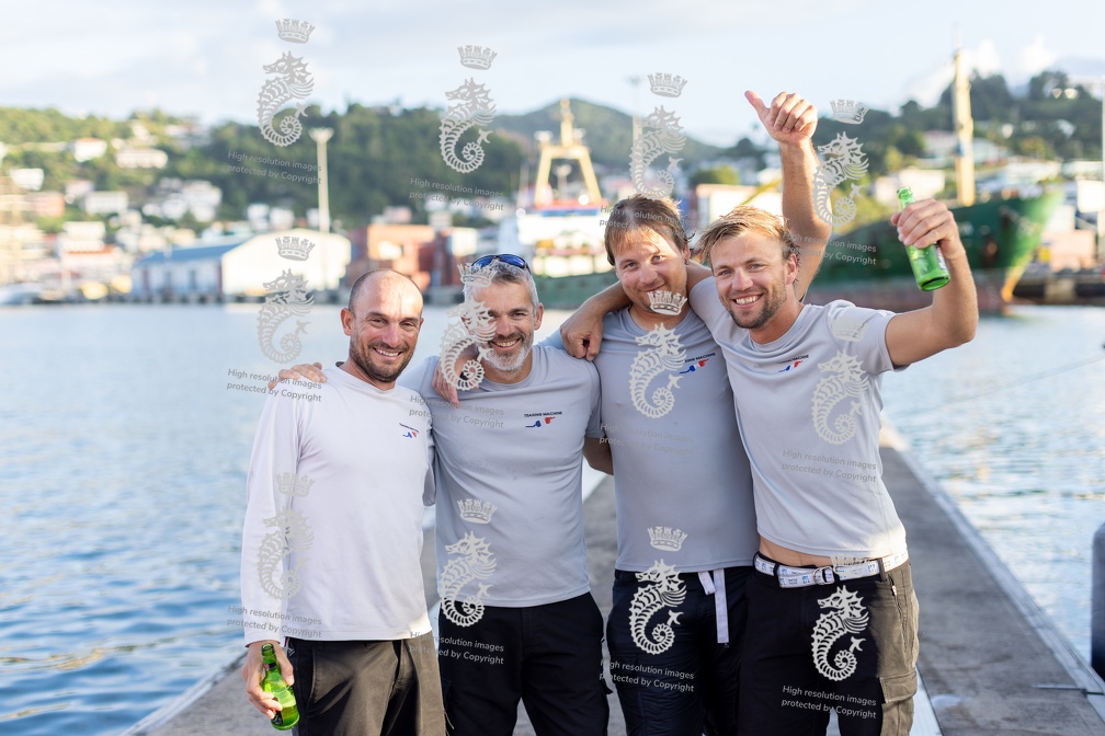 Crew celebrate together after the finish of a hard race