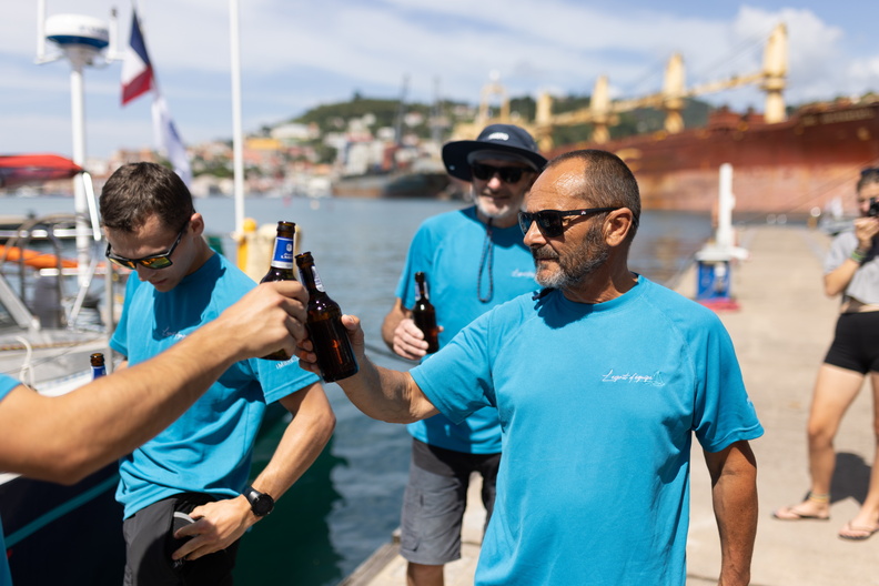 L'Esprit d'Equipe skipper Lionel Regnier celebrates their race on the dock