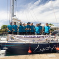 L'esprit d'Equipe celebrate with the race banner in Grenada