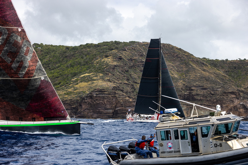 Emerald Racing Team sailing VO70 Hypr sails past the Antigua Coast Guard