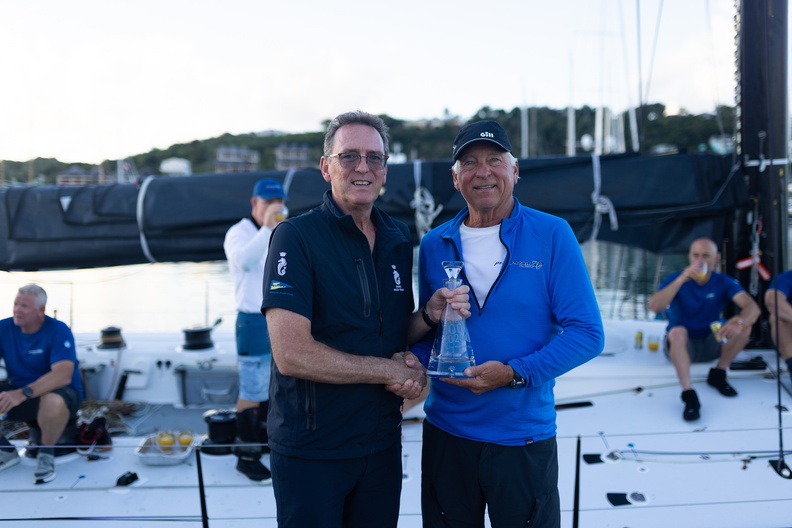 RORC CEO Jeremy Wilton greets Pyewacket skipper Ben Mitchell with the monohull line honours decanter