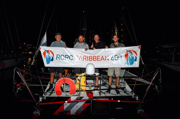 Tquila's crew pose with the race banner