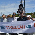 Influence's crew pose with the race banner