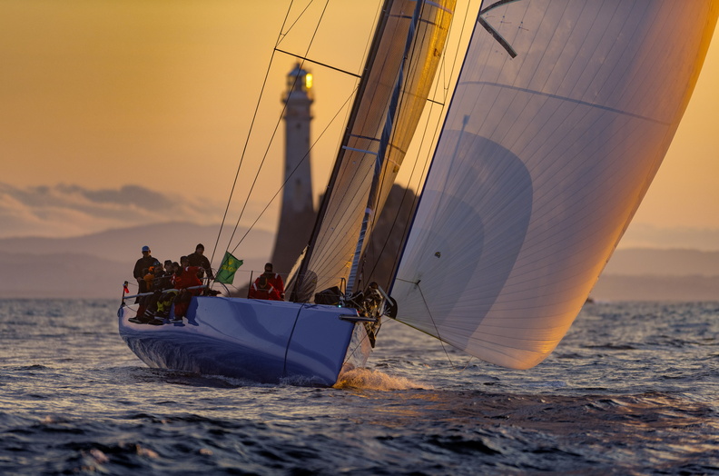 THE AMERICAN YACHT, WARRIOR WON, ROUNDS THE FASTNET ROCK AT DAWN DURING THE 50TH ROLEX FASTNET RACE.