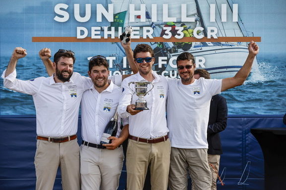 Francois Charles (left) and crew of Sun Hill III pick up the Iolaire Cup for 1st in IRC Four