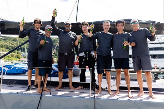 The Team 42 crew line up with their celebratory beers