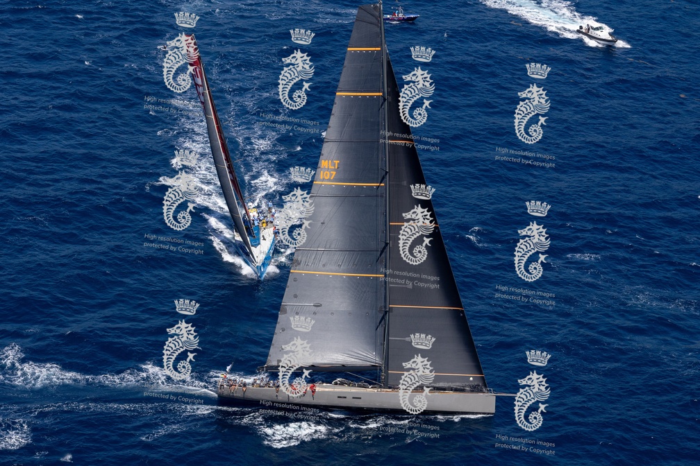 Crew of Spirit of Malouen X, sailed by Paprec Sailing Team and skippered by Stephane Neve, with Ocean Breeze on the opposite tack