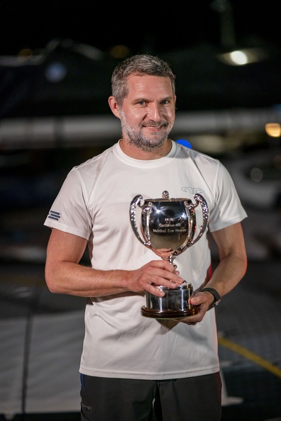 Argo owner Jason Carroll poses with the trophy for first multihull to finish