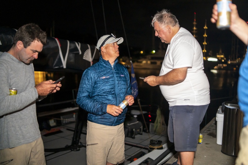Louay Habib debriefs with one of the Askew brothers and skipper Charlie Enright