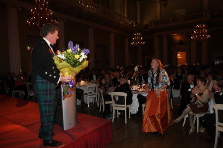 Commodore Andrew McIrvine presents Margaret Carnell with a thank you gift