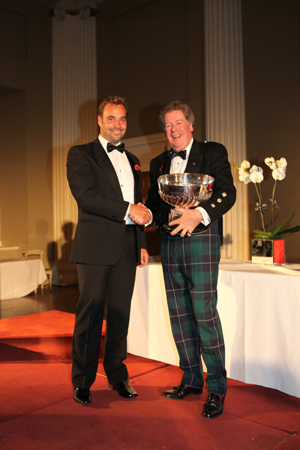 Commodore Andrew McIrvine presents the Somerset Memorial Trophy to Philippe Falle, Puma Logic